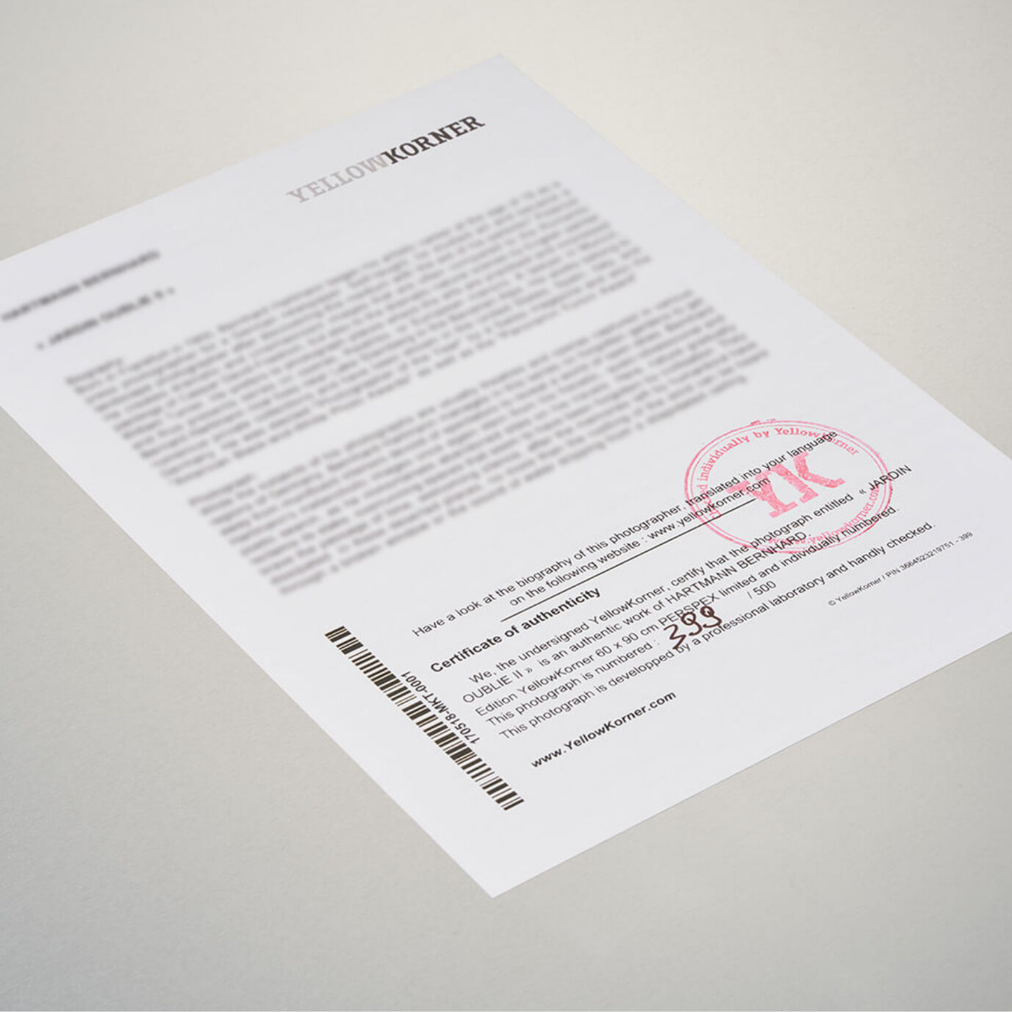 Document with a red stamp on a light gray background