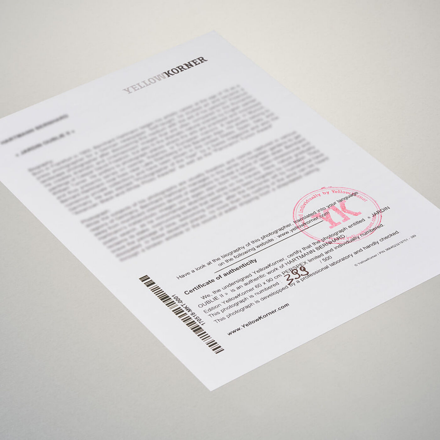 Document with a red stamp and text on a gray surface