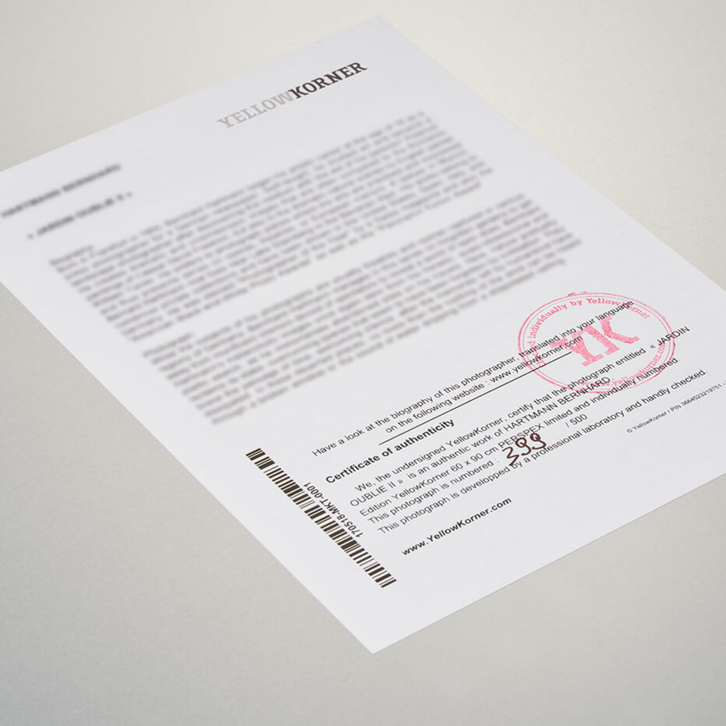 Document with a red stamp and text on a light gray background