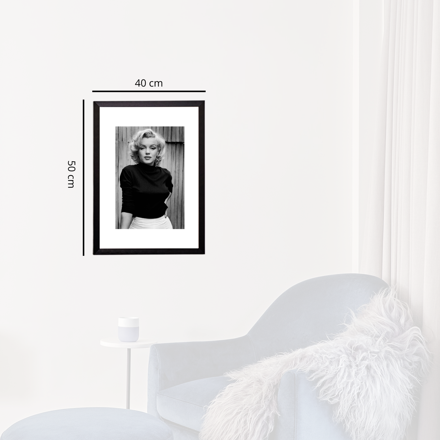 Framed black and white portrait of a woman on a white wall with dimensions indicated.