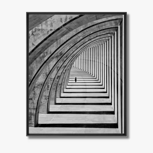 Framed black and white art print of a geometric pattern with a person at the end.