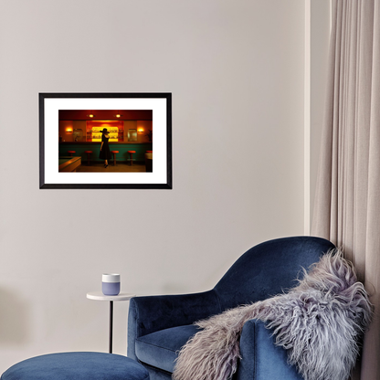 Framed artwork on a wall above a blue armchair with a fur throw.
