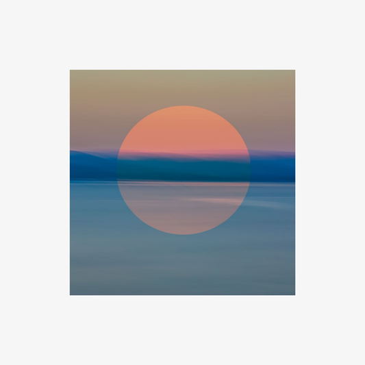 Surreal sunset over water with a large orange circle