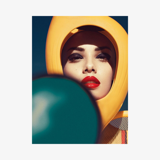 Woman wearing a yellow hood with a blue background