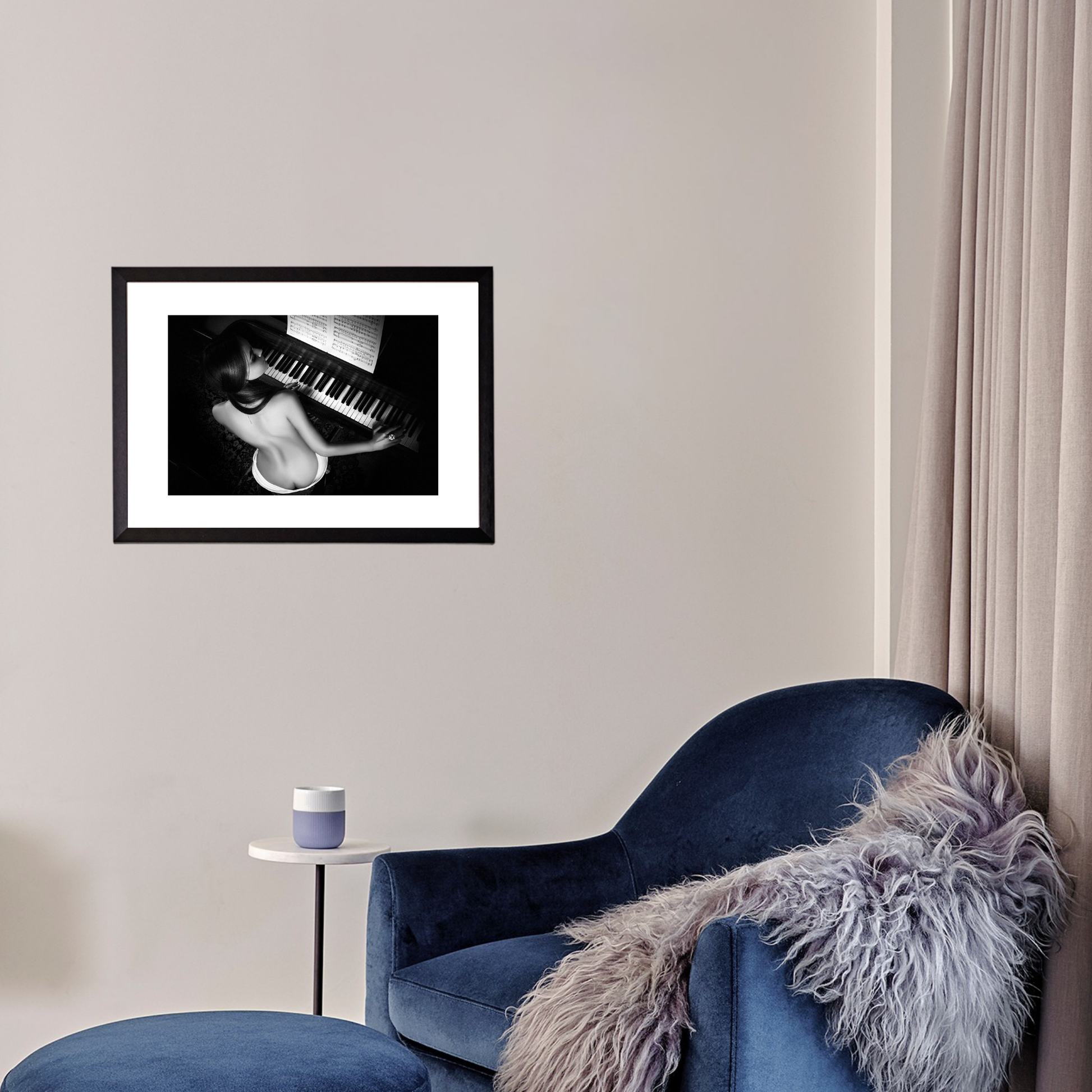 Blue armchair with a fur throw in a room with a framed picture on the wall.