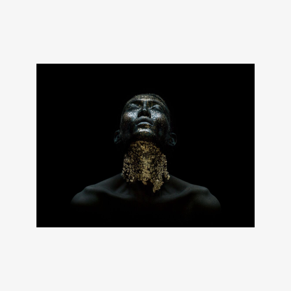 Man with a beard against a black background
