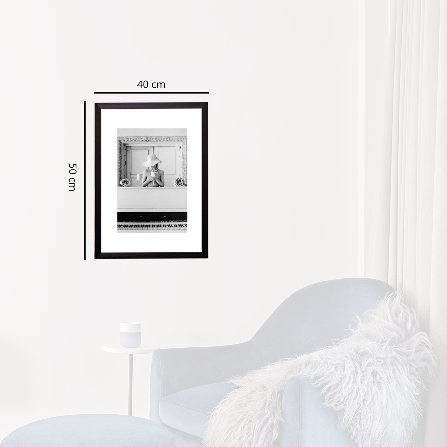 Framed black and white photo on a white wall with dimensions indicated