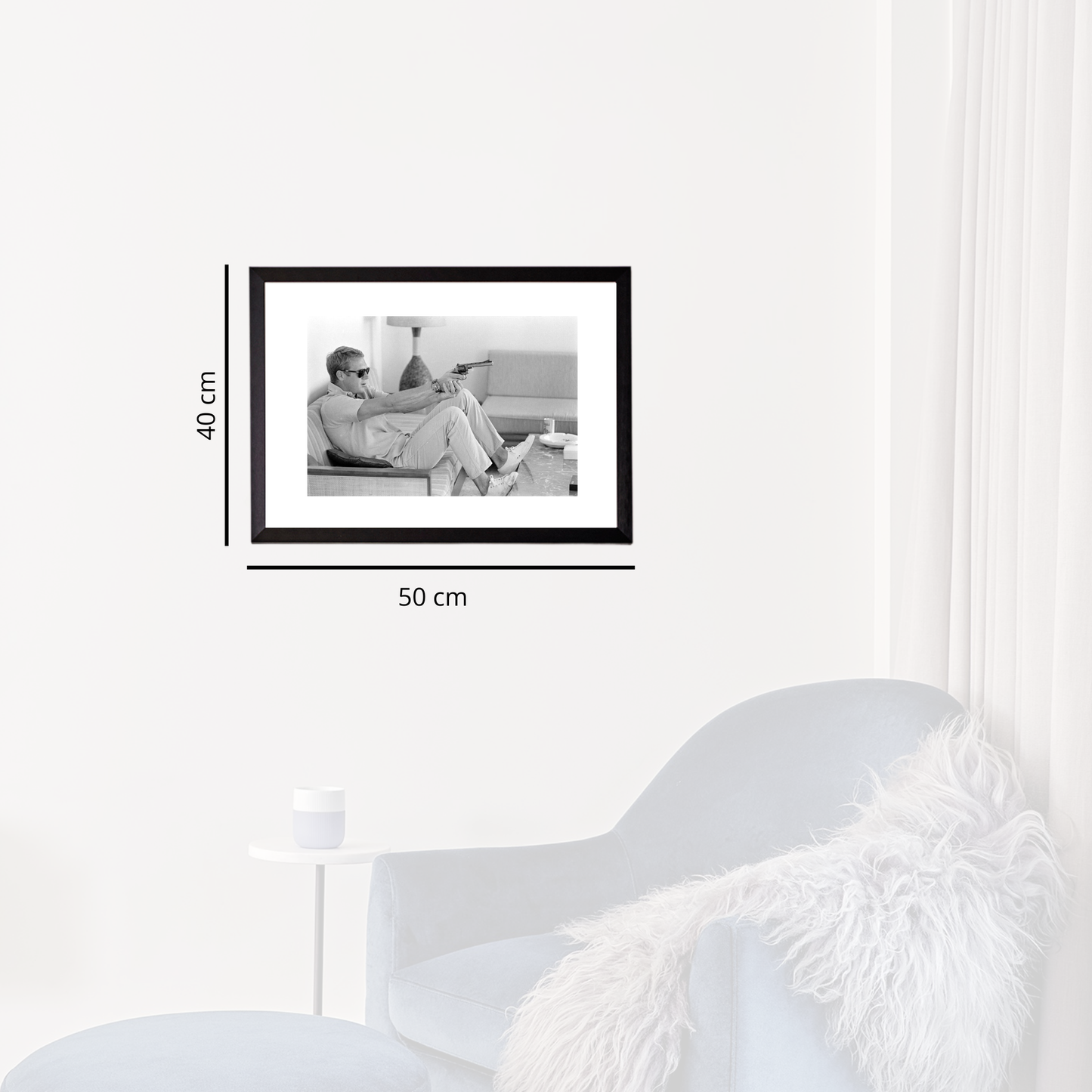 Black photo frame on a white wall with dimensions indicated