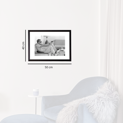 Black photo frame on a white wall with dimensions indicated