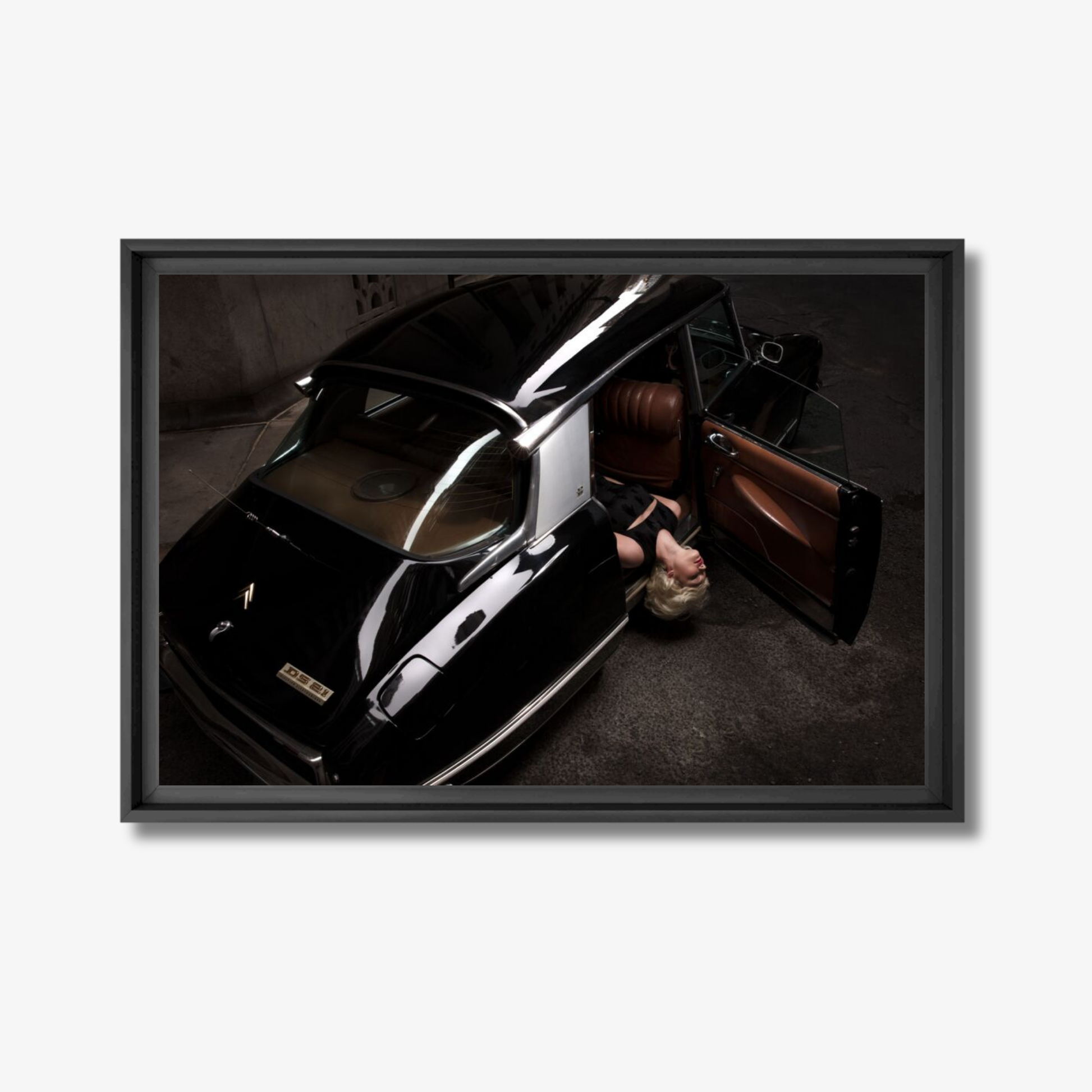 Framed photograph of a classic car with an open door on a white background