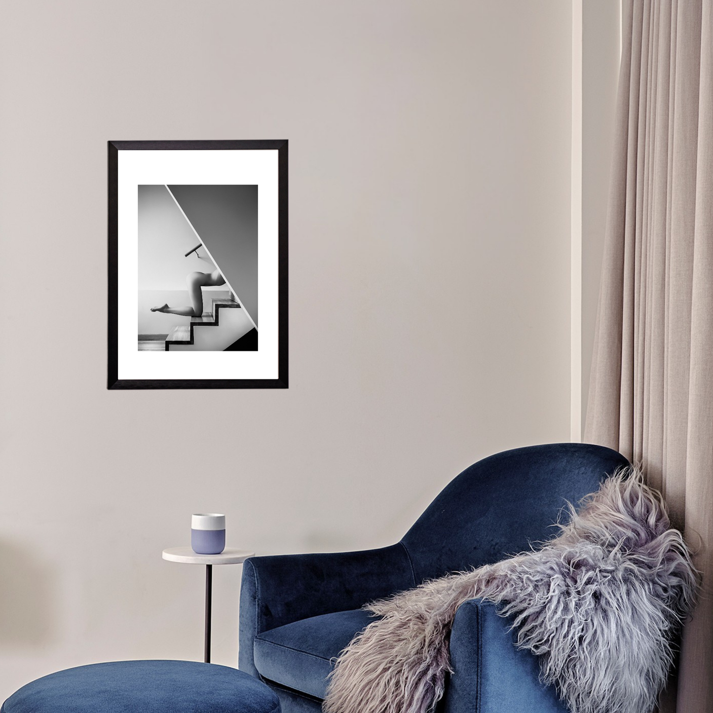 Blue armchair with a fur throw in a room with a framed picture on the wall.