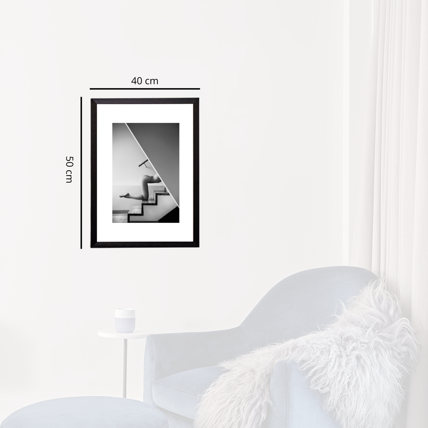 Framed black and white abstract art on a white wall with dimensions indicated.