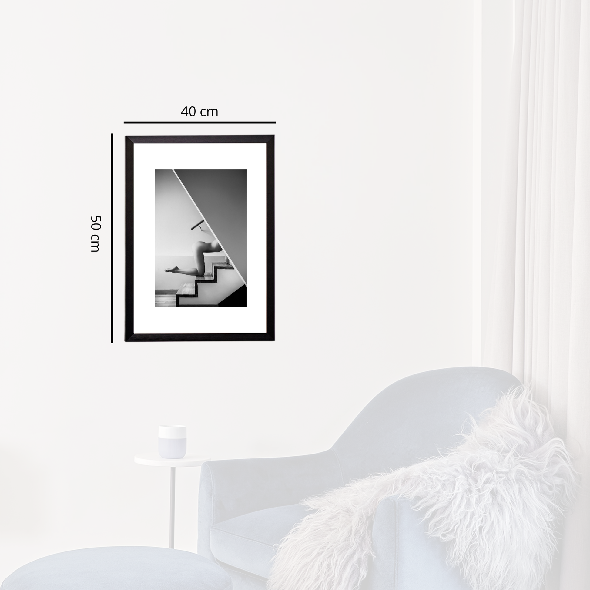 Framed black and white abstract art on a white wall with dimensions indicated.