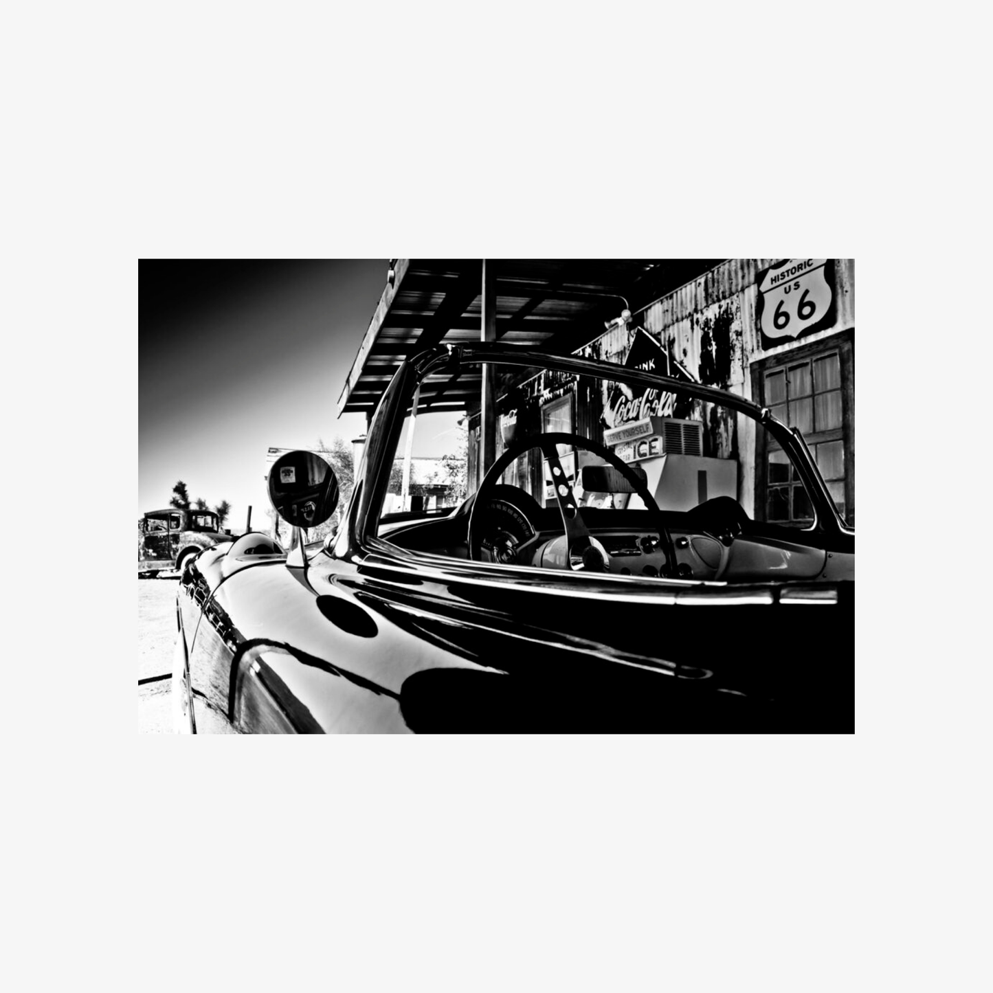 Vintage car interior with a cityscape background featuring Route 66.