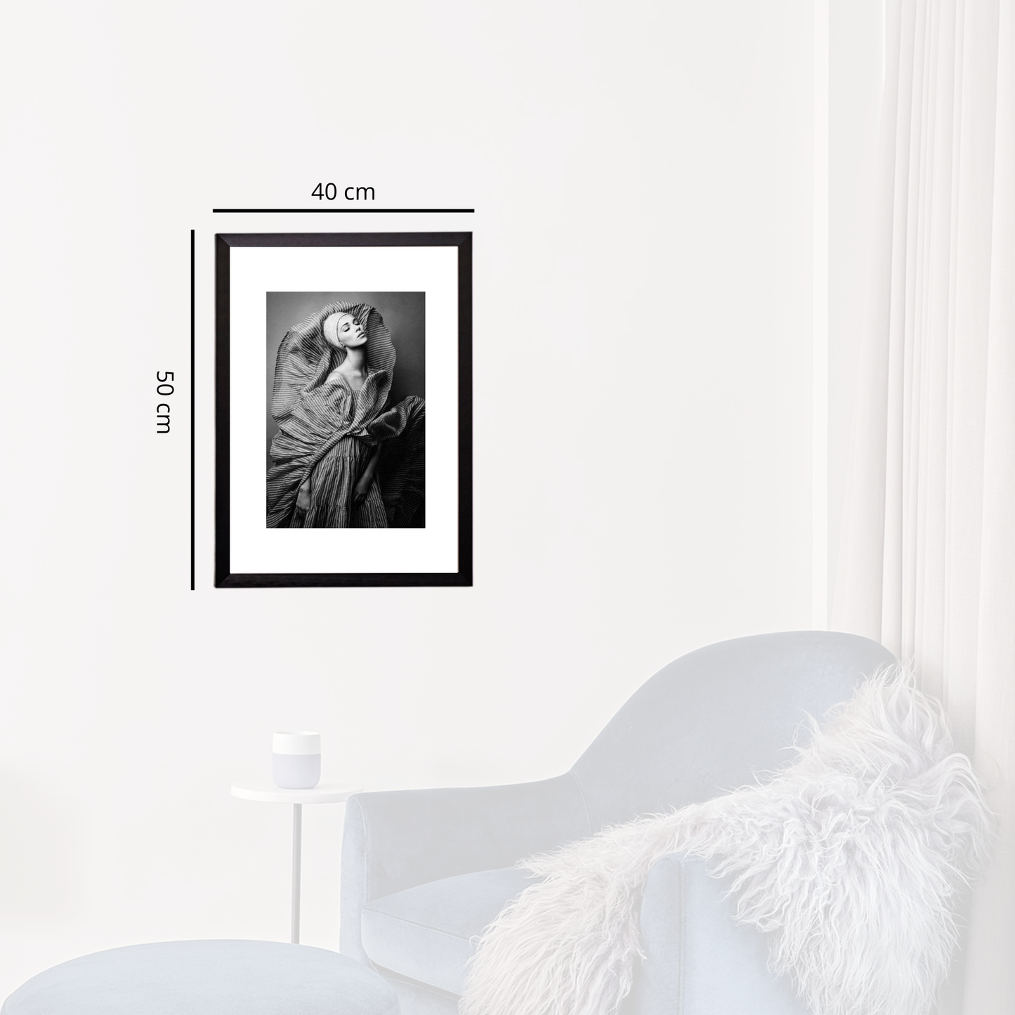 Framed black and white photo on a white wall with dimensions indicated