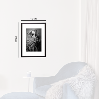Framed black and white photo on a white wall with dimensions indicated