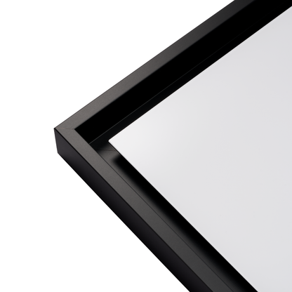 Close-up of a black-framed mirror on a white background