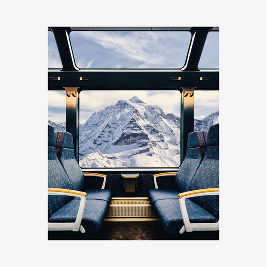 Train interior with a large window showing a mountain view