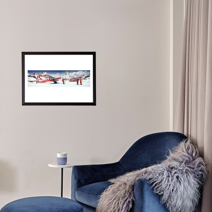 Framed picture of a red airplane on a snowy landscape above a blue armchair with a fur throw.