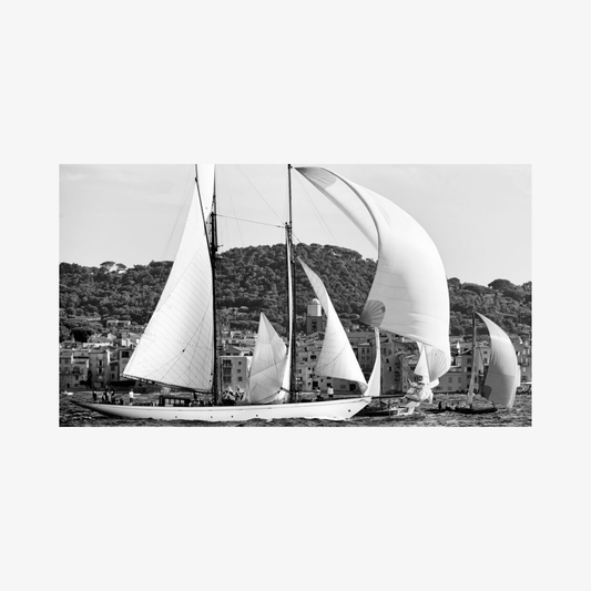 Black and white photograph of sailboats with a coastal town in the background