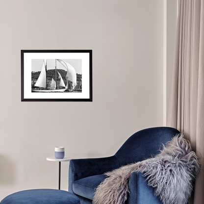 Blue armchair with a fur throw in a room with a framed black and white photograph on the wall.