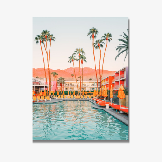 Pool area with palm trees and buildings at sunset