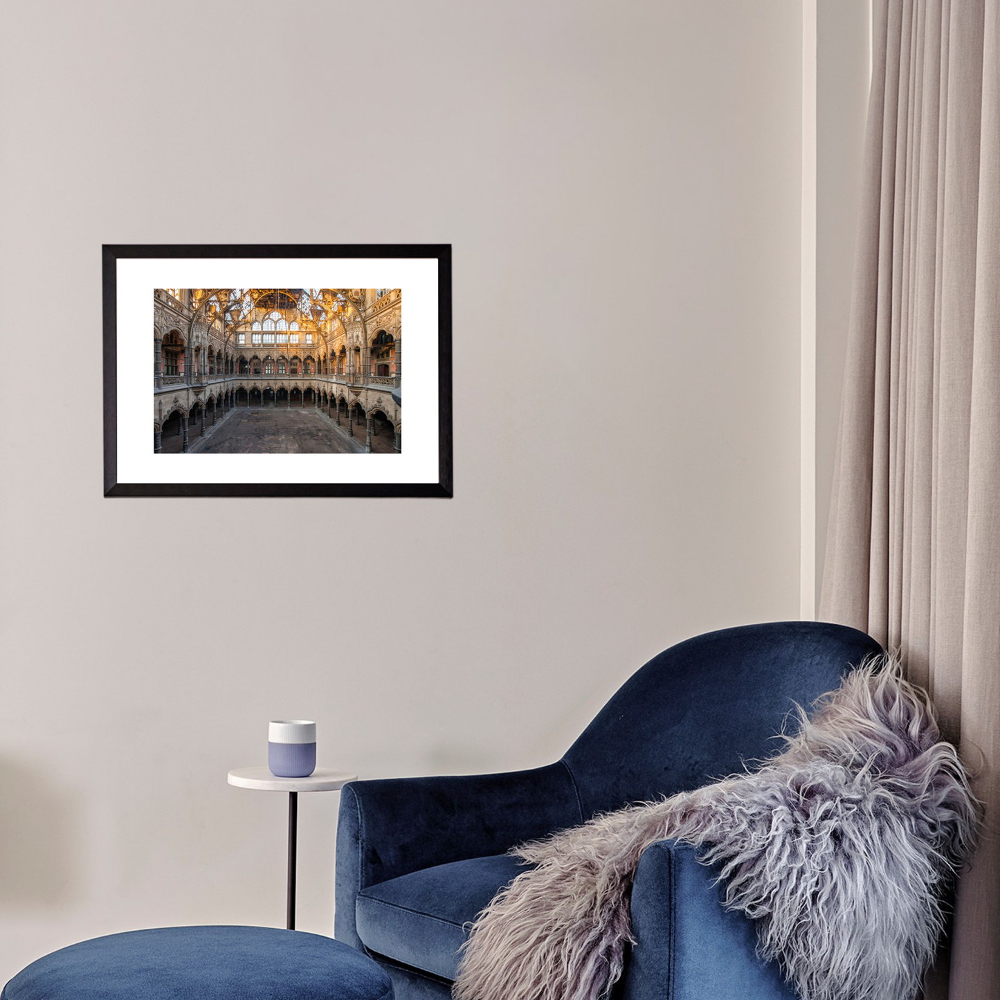 Blue armchair with a fur throw in a room with a framed picture on the wall.