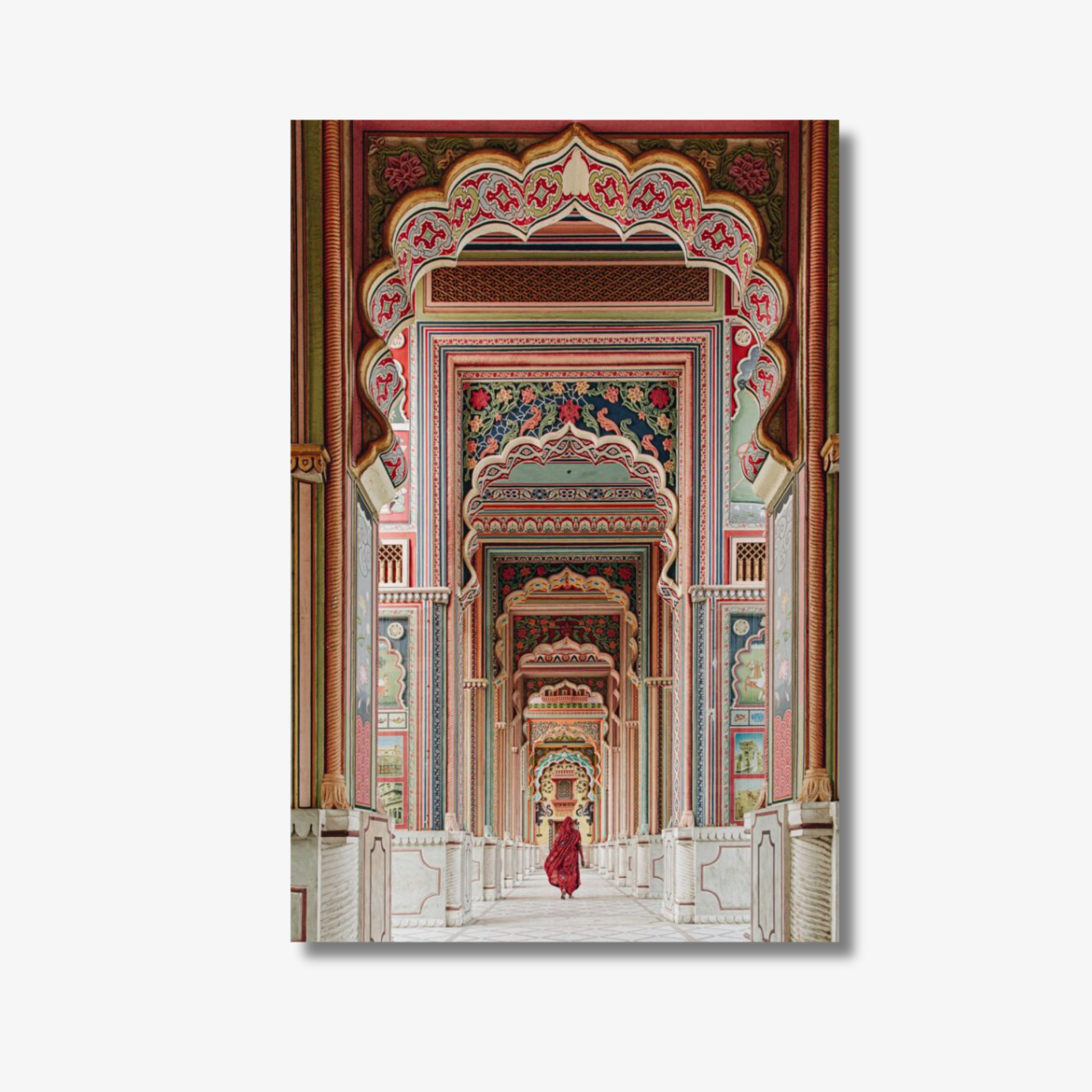 Decorative wall art of an ornate architectural design with a person in red clothing walking through.