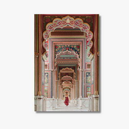 Decorative wall art of an ornate architectural design with a person in red clothing walking through.