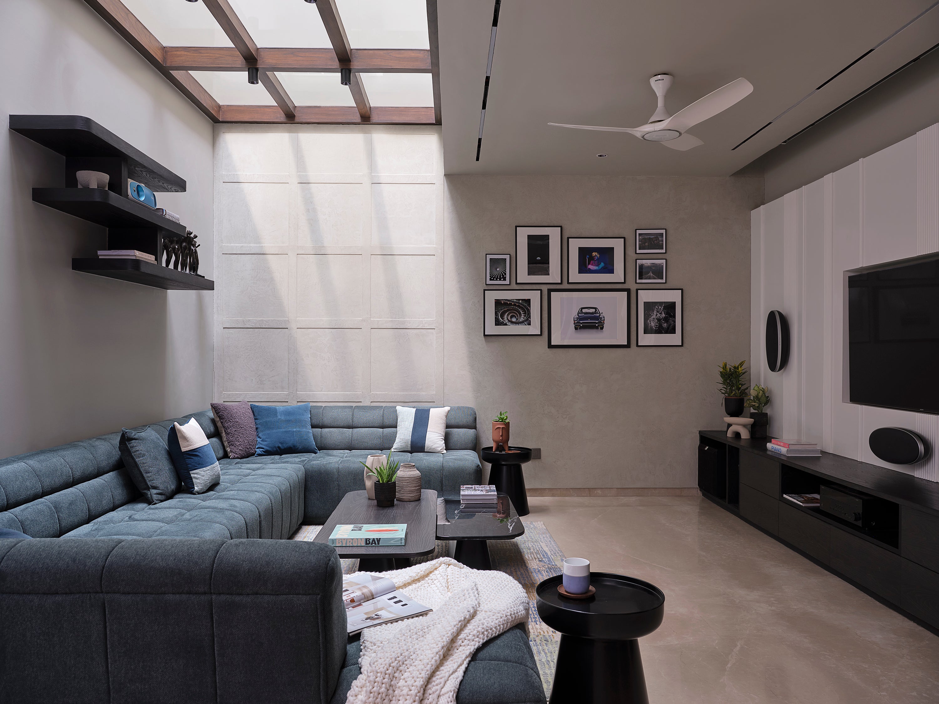 Modern living room with gray sectional sofa, coffee table, and wall art. lounge room interior decoration wall decor ideas bedroom wall decor ideas